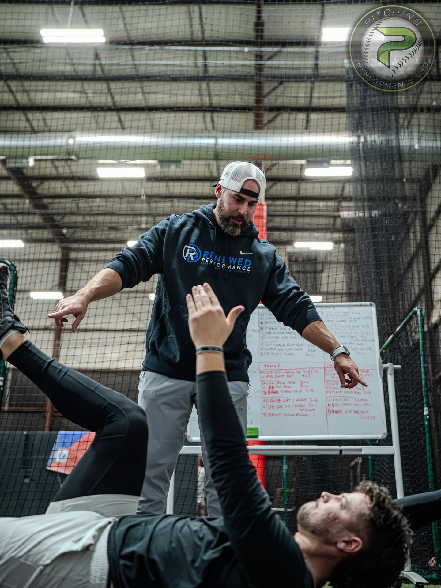 A PPL coach running a movement assessment