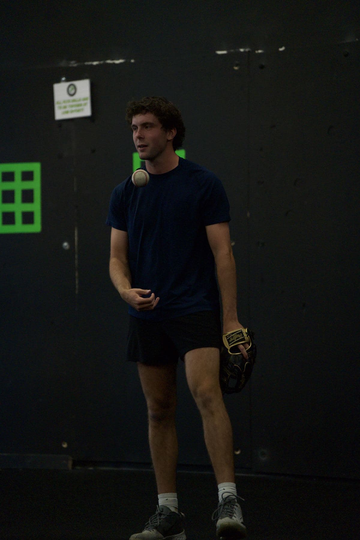 A pitcher standing in front of a strike zone target on the wall at PPL with his glove